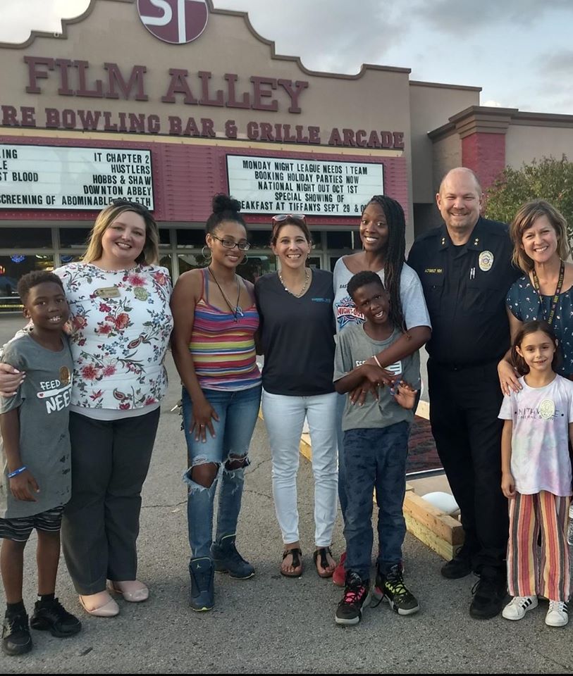 group of community members at event in front of movie theater