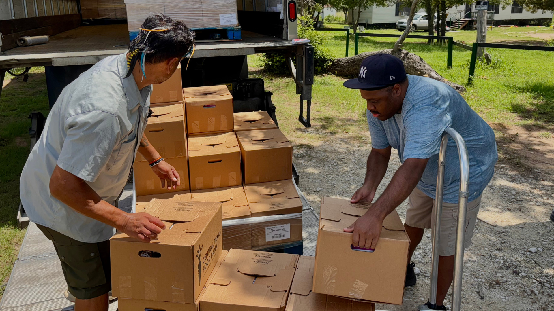 Unloading food boxes off of a truck with Central Texas Food Bank