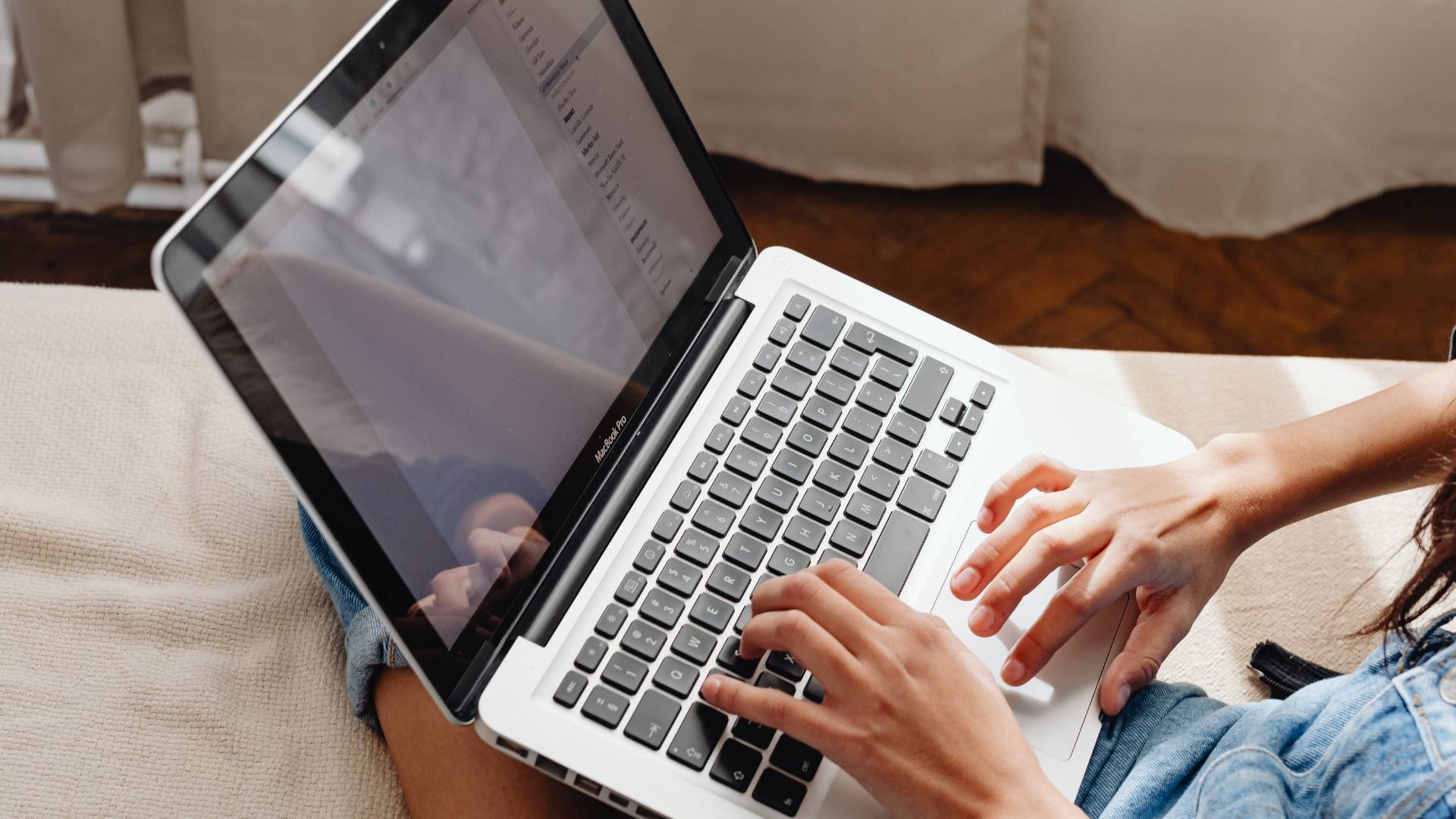 Person using a laptop to type and navigate digital tools