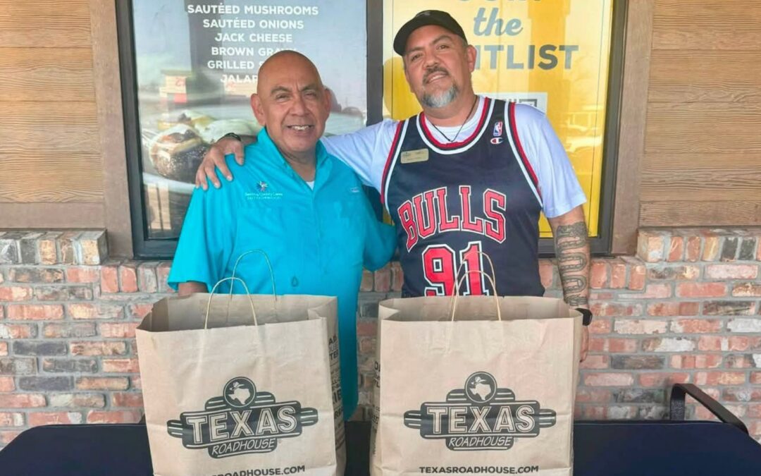 Bastrop County Cares staff meet with the Texas Roadhouse Bastrop managing partner during the restaurant's soft opening charity partnership event.