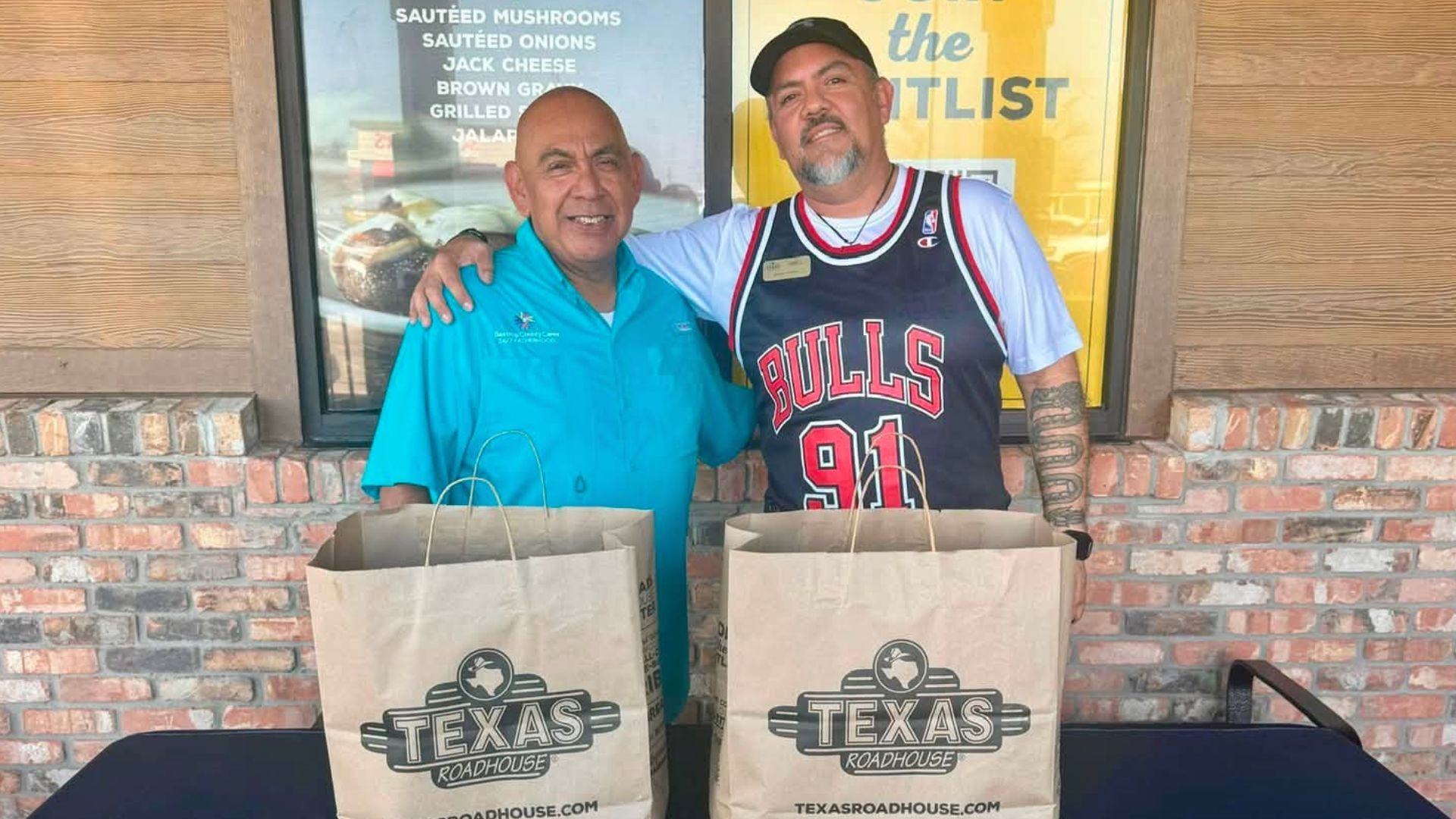 Bastrop County Cares staff meet with the Texas Roadhouse Bastrop managing partner during the restaurant's soft opening charity partnership event.